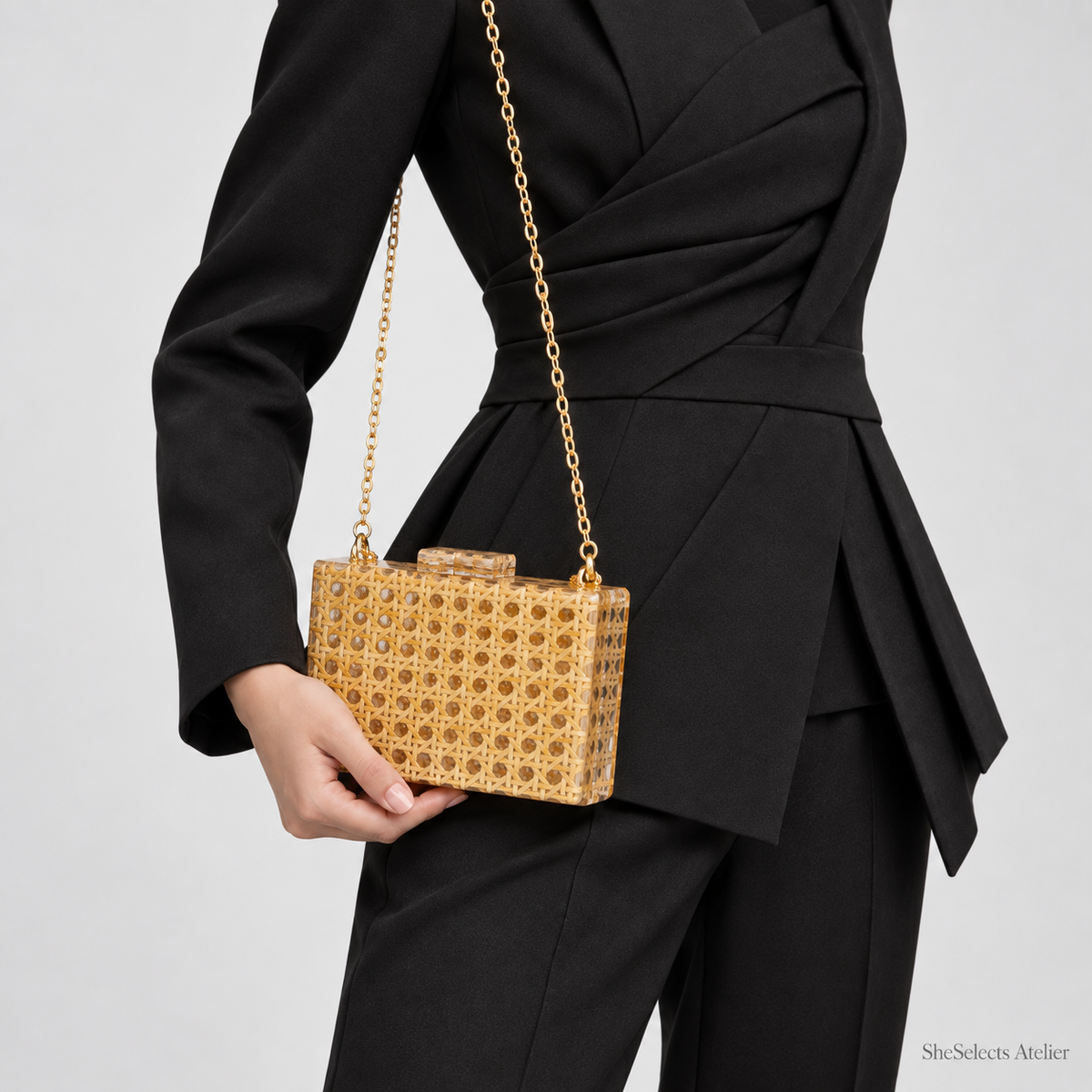Aurelia bag worn on the shoulder with a black tailored outfit