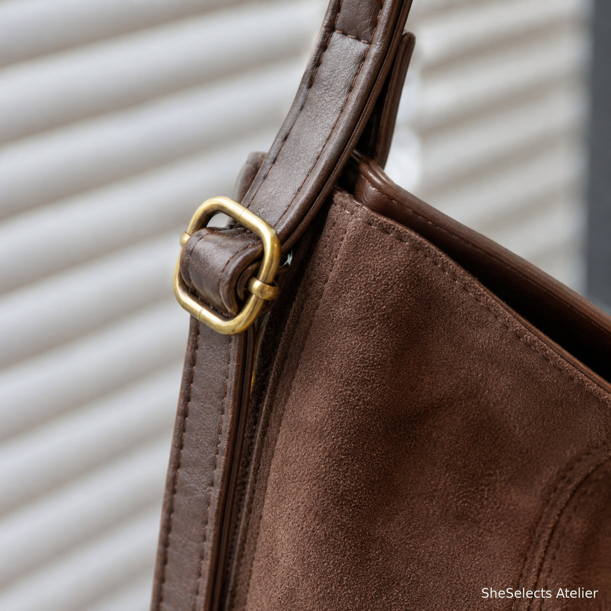 Adjustable strap hardware and faux suede texture close-up