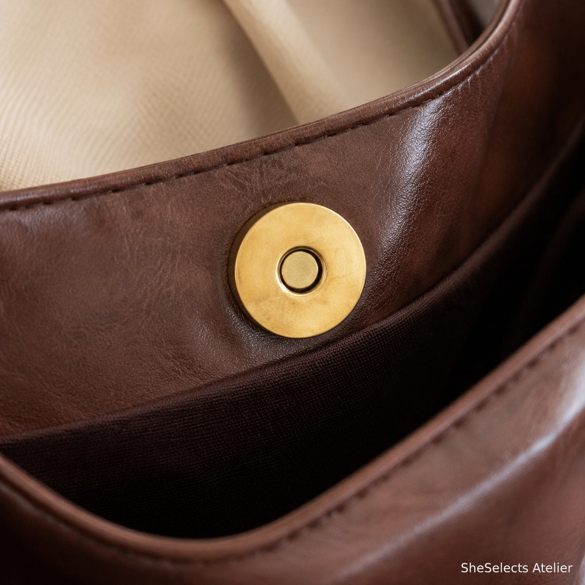 Gold tone magnetic snap closure close up
