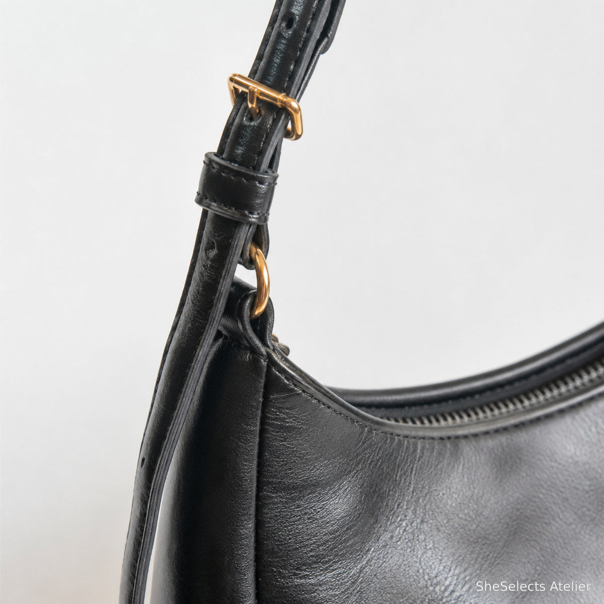 Adjustable strap buckle and gold ring close up