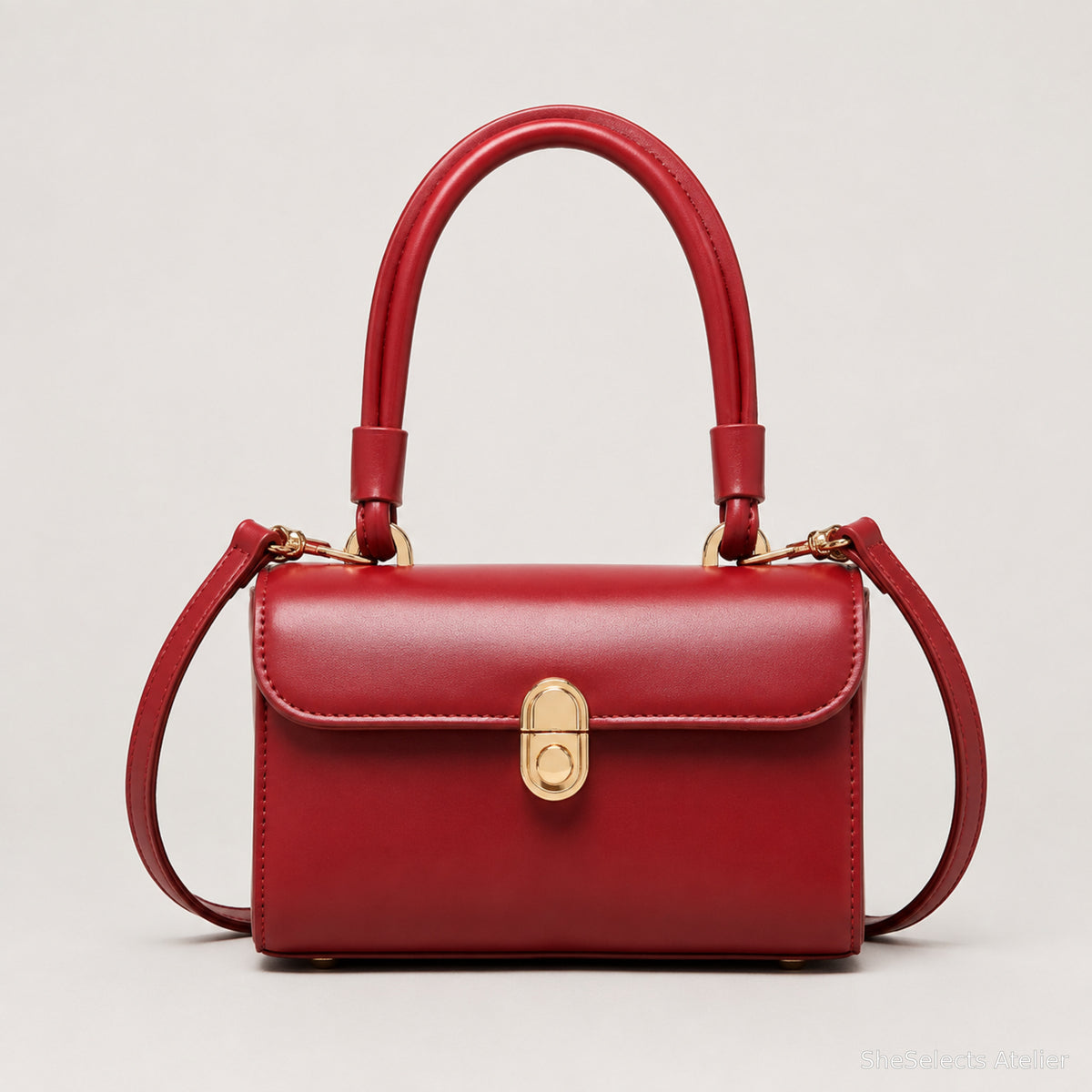 Red structured shoulder purse front view with gold clasp