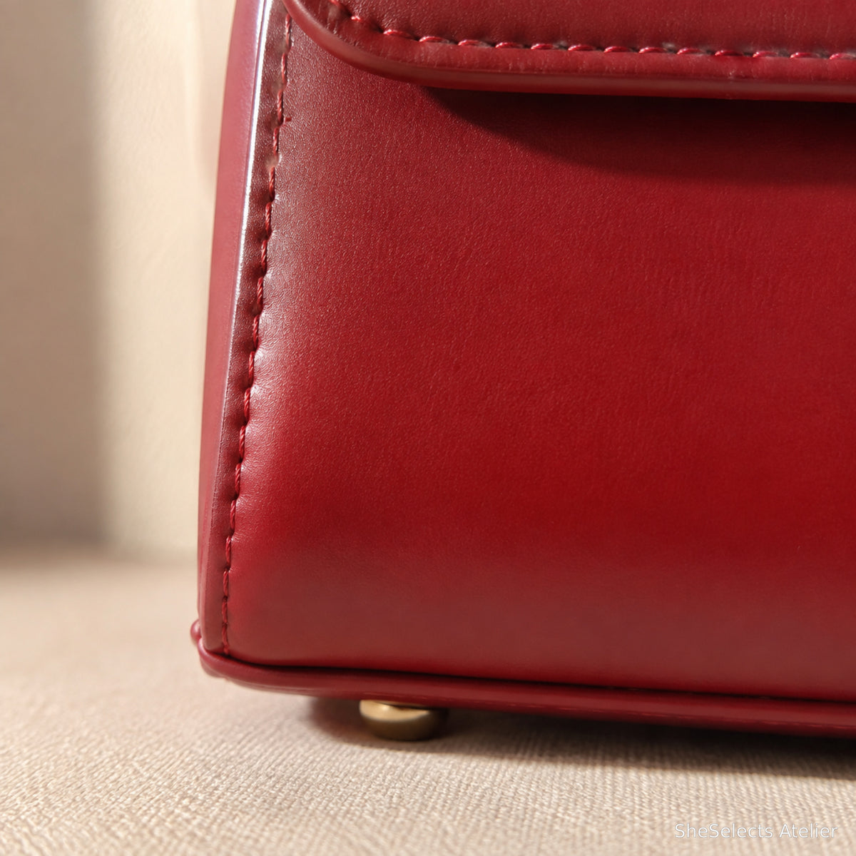 Red handbag stitching and base foot close-up
