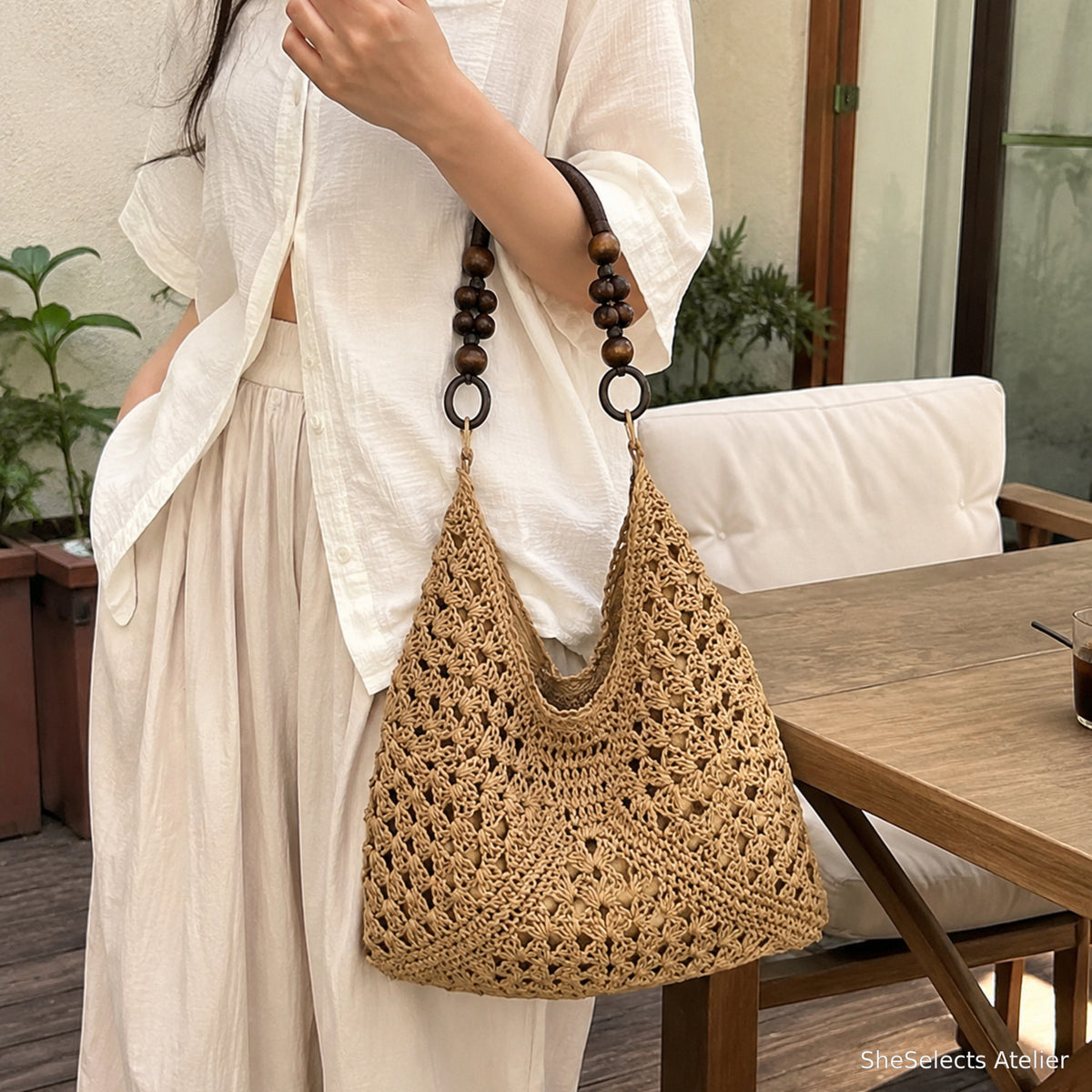 Khaki woven hobo tote carried with a neutral resort outfit