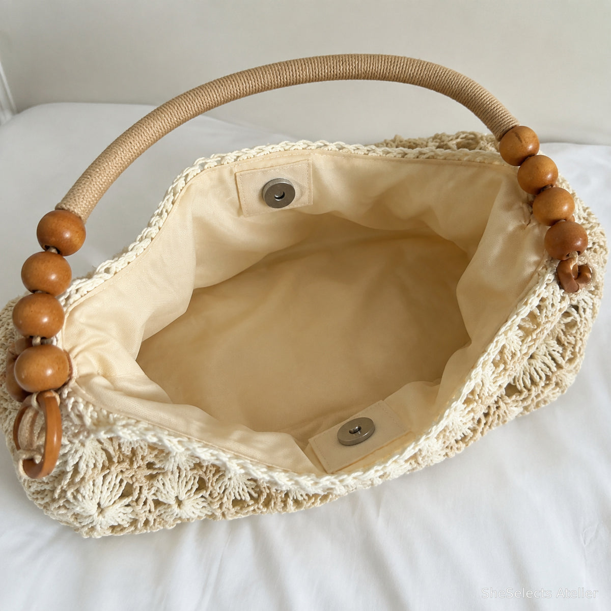 Verified cream lined interior of beige woven tote with magnetic snap